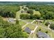 Wide angle elevated aerial view showcases home within a community surrounded by mature trees and farmland at 203 Poplins Grove Church Rd, Albemarle, NC 28001
