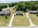 Aerial view of this home situated on a well-maintained, grassy lot surrounded by mature trees and other houses at 203 Poplins Grove Church Rd, Albemarle, NC 28001
