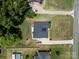 Aerial view of the property featuring a well-maintained lawn, landscaping, and a paved driveway at 203 Poplins Grove Church Rd, Albemarle, NC 28001