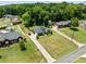 Aerial view showcasing this home on a vast green lot, with mature trees and a long driveway at 203 Poplins Grove Church Rd, Albemarle, NC 28001