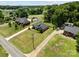 Aerial view showcasing the home on a sprawling lot with long driveways leading to the house at 203 Poplins Grove Church Rd, Albemarle, NC 28001