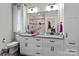 Bright bathroom featuring a dual-sink vanity with granite countertop and tiled shower at 203 Poplins Grove Church Rd, Albemarle, NC 28001