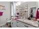 Bright bathroom featuring a dual-sink vanity with granite countertop and tiled shower at 203 Poplins Grove Church Rd, Albemarle, NC 28001