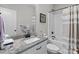 Modern bathroom with granite vanity, white cabinets, and a shower-tub combination at 203 Poplins Grove Church Rd, Albemarle, NC 28001