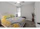 Bedroom with a patchwork quilt, ceiling fan, and a bright, airy feel at 203 Poplins Grove Church Rd, Albemarle, NC 28001