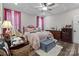Cozy bedroom featuring stylish decor, including a bed, desk, armchair, and dresser at 203 Poplins Grove Church Rd, Albemarle, NC 28001