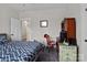 Bedroom with a patterned comforter, wooden desk, and a serene atmosphere at 203 Poplins Grove Church Rd, Albemarle, NC 28001