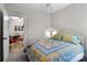 Bedroom with patchwork quilt and ceiling fan, showing an open doorway at 203 Poplins Grove Church Rd, Albemarle, NC 28001
