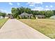 Charming home featuring a long driveway and lush greenery, offering a peaceful and inviting atmosphere at 203 Poplins Grove Church Rd, Albemarle, NC 28001