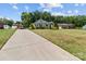 Picturesque home with a long driveway, lush greenery, and well-maintained landscaping, offering great curb appeal at 203 Poplins Grove Church Rd, Albemarle, NC 28001