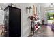 Stylish foyer with wood floors, decorated with flowers and a large armoire at 203 Poplins Grove Church Rd, Albemarle, NC 28001