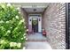 Charming front porch with floral wreath, rocking chair, and a welcoming doormat at 203 Poplins Grove Church Rd, Albemarle, NC 28001