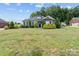 Charming single-story brick home with a large front lawn and well-maintained landscaping and black shutters at 203 Poplins Grove Church Rd, Albemarle, NC 28001