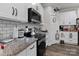 Modern kitchen featuring stainless steel appliances, granite counters and subway tile backsplash at 203 Poplins Grove Church Rd, Albemarle, NC 28001