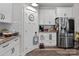 Charming kitchen with white cabinetry, stainless steel refrigerator, and subway tile backsplash at 203 Poplins Grove Church Rd, Albemarle, NC 28001