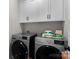 Well-equipped laundry area with modern washer and dryer, plus upper cabinets for storage at 203 Poplins Grove Church Rd, Albemarle, NC 28001