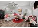 Cozy living room with wood floors, comfortable white sofa, and bright, airy atmosphere at 203 Poplins Grove Church Rd, Albemarle, NC 28001