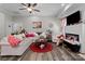 Bright living room with a fireplace, comfortable seating, and a ceiling fan at 203 Poplins Grove Church Rd, Albemarle, NC 28001