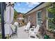 Outdoor patio with seating area, grill, umbrella, and view of the well-maintained brick exterior at 203 Poplins Grove Church Rd, Albemarle, NC 28001