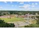 Aerial view of a commercial district, lake and surrounding green space under cloudy skies at 205 Church St, Mcadenville, NC 28101