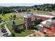 Aerial view of a building with brick towers next to a green lawn and a pond at 205 Church St, Mcadenville, NC 28101