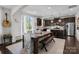 Dining area with a dark wood table and bench, kitchen access, and natural light at 205 Church St, Mcadenville, NC 28101