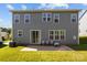Back exterior of the house with a patio, well-maintained lawn, and gray siding at 205 Church St, Mcadenville, NC 28101