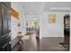 Bright foyer with dark wood floors, bench seating, and views of the dining room at 205 Church St, Mcadenville, NC 28101