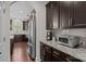 Open kitchen with granite countertops, stainless steel refrigerator, and dark wood cabinets at 205 Church St, Mcadenville, NC 28101
