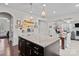 Kitchen island with granite countertops and dark wood cabinetry, open to the dining area at 205 Church St, Mcadenville, NC 28101