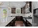 Modern kitchen featuring granite countertops, stainless steel appliances, and dark wood cabinetry at 205 Church St, Mcadenville, NC 28101