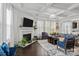 Spacious living room featuring coffered ceilings, fireplace, and open layout with hardwood floors at 205 Church St, Mcadenville, NC 28101