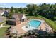 Aerial shot of a pool area surrounded by chairs and umbrellas, set amongst the trees at 205 Church St, Mcadenville, NC 28101