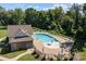 Aerial view of a community pool area with an umbrella table and plenty of lounge chairs at 205 Church St, Mcadenville, NC 28101