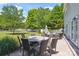 Landscaped backyard features a dining set, sitting area, mature trees, and lush lawn at 2090 Durand Rd, Fort Mill, SC 29715