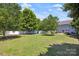 Large fenced backyard features lush grass, mature trees, and trampoline for outdoor fun at 2090 Durand Rd, Fort Mill, SC 29715