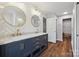 Bathroom featuring double sink vanity with stone countertop and herringbone backsplash at 2090 Durand Rd, Fort Mill, SC 29715