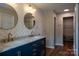 Luxurious bathroom with dual sinks, granite counters, modern lighting, and herringbone tile at 2090 Durand Rd, Fort Mill, SC 29715