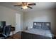 Cozy bedroom featuring a comfortable bed, fan, and desk setup at 2090 Durand Rd, Fort Mill, SC 29715