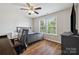 Bedroom features a ceiling fan, natural light, hardwood floors, modern desk, and gray furniture set at 2090 Durand Rd, Fort Mill, SC 29715