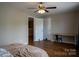 Spacious bedroom with hardwood floors, neutral walls, and a desk with chair near the door at 2090 Durand Rd, Fort Mill, SC 29715