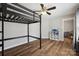 Minimalist bedroom features a loft bed, sleek wood floors, and a modern white storage shelf with decor at 2090 Durand Rd, Fort Mill, SC 29715
