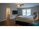 Well lit bedroom featuring hardwood floors and a wall-mounted TV above modern furniture at 2090 Durand Rd, Fort Mill, SC 29715