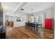 Open-concept dining area with hardwood floors, modern chandelier, and views into living room at 2090 Durand Rd, Fort Mill, SC 29715