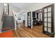 Spacious foyer featuring hardwood floors, a staircase, and doorway to a music room at 2090 Durand Rd, Fort Mill, SC 29715