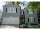 Charming two-story home with a bright teal front door, black shutters, and attached garage at 2090 Durand Rd, Fort Mill, SC 29715