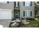 Inviting front exterior with a teal door, black shutters, and landscaped yard at 2090 Durand Rd, Fort Mill, SC 29715