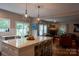 Open-concept kitchen featuring a large island with seating and views of the living room and backyard at 2090 Durand Rd, Fort Mill, SC 29715