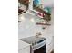 Bright kitchen features a stainless steel range hood, cooktop, modern appliances, and decorative open shelving with globes at 2090 Durand Rd, Fort Mill, SC 29715