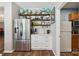 Bright kitchen showcases stainless steel refrigerator and coffee bar, with wooden shelving and globe decorations at 2090 Durand Rd, Fort Mill, SC 29715